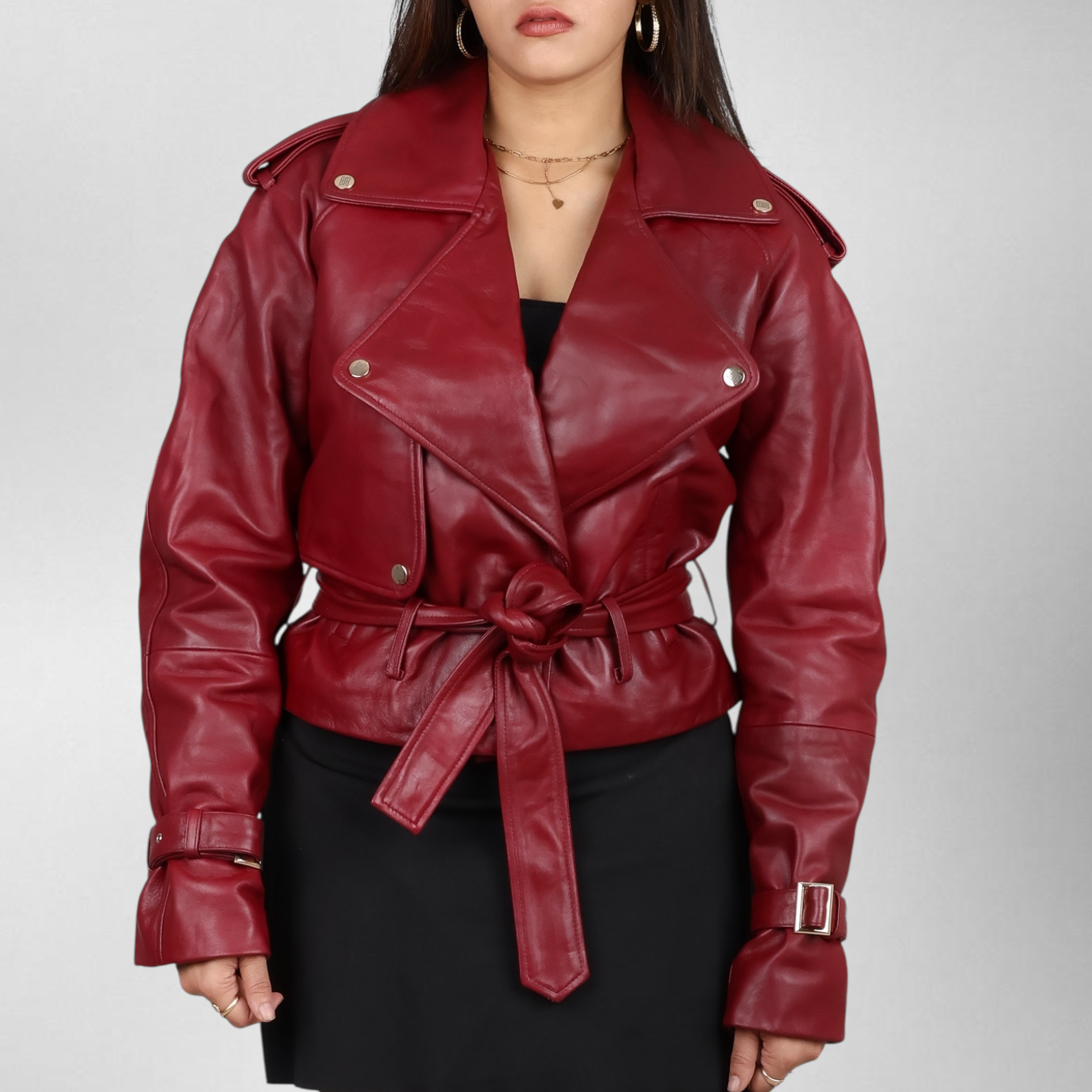Woman wearing a red leather jacket with a belt on a gray background Blaatan The Cordova Crimson Edition Crimson Burgundy Party Wear Leather Jacket for Women