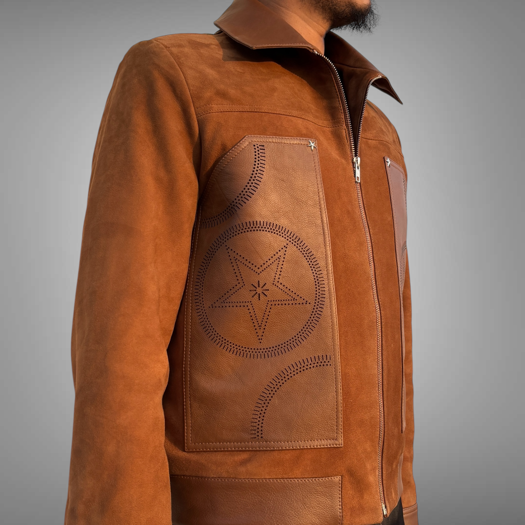 Brown suede leather jacket with star design on a gray background by Blaatan