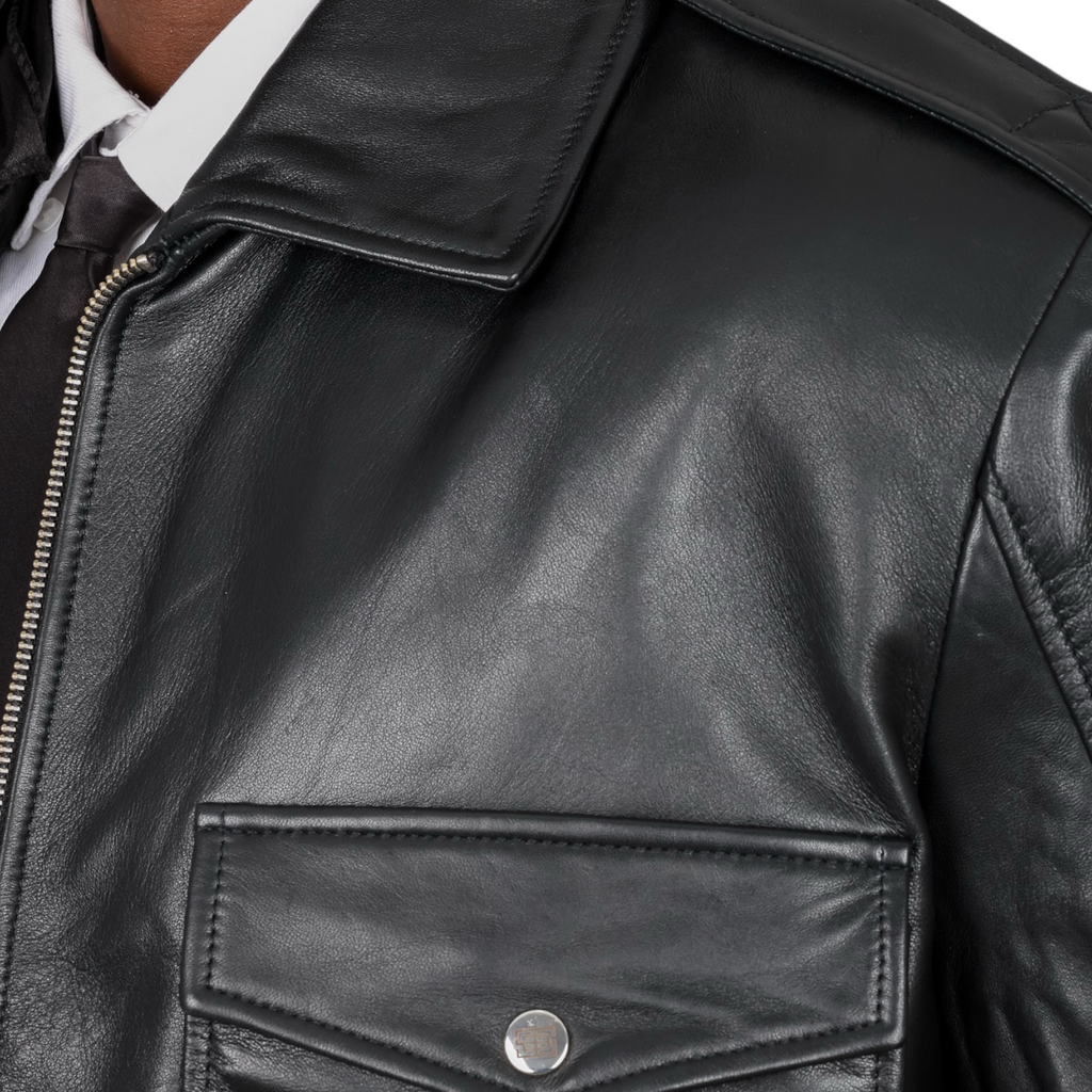 Close-up of a black leather jacket with a zipper and button detail. Blaatan The Marshal Flight Edition Obsidian Black Aviator Bomber Leather Jacket for Men