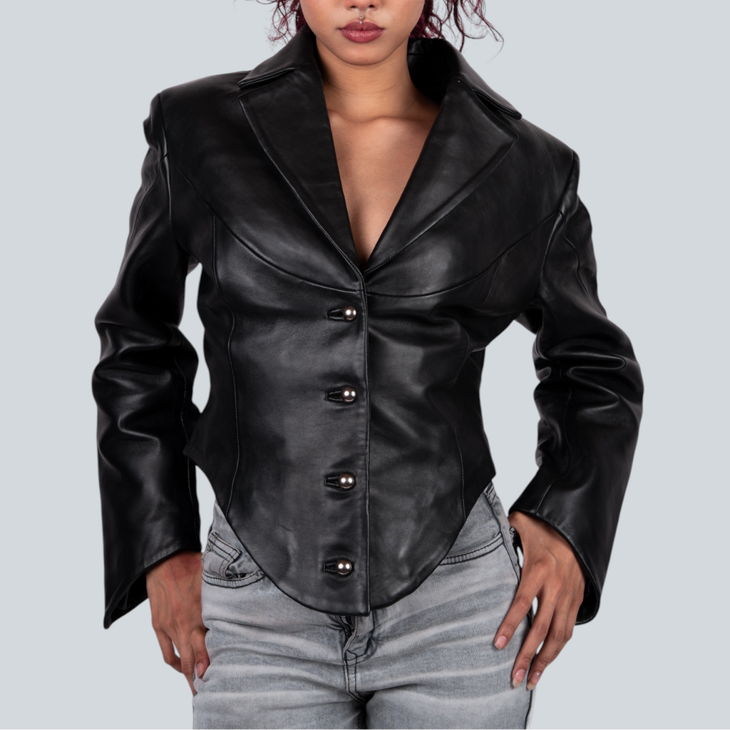 Woman wearing a black leather jacket on a gray background